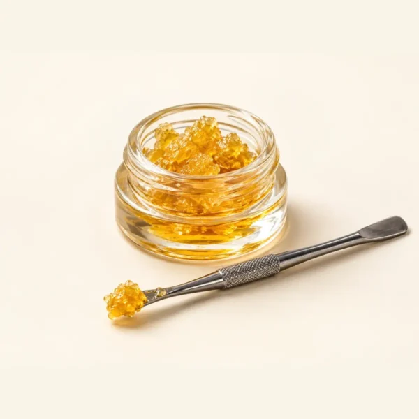 A jar of concentrate with a dab tool